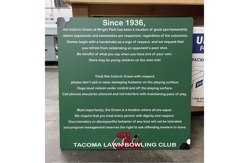 Green outdoor sign panel listing Tacoma Lawn Bowling Club rules in white type