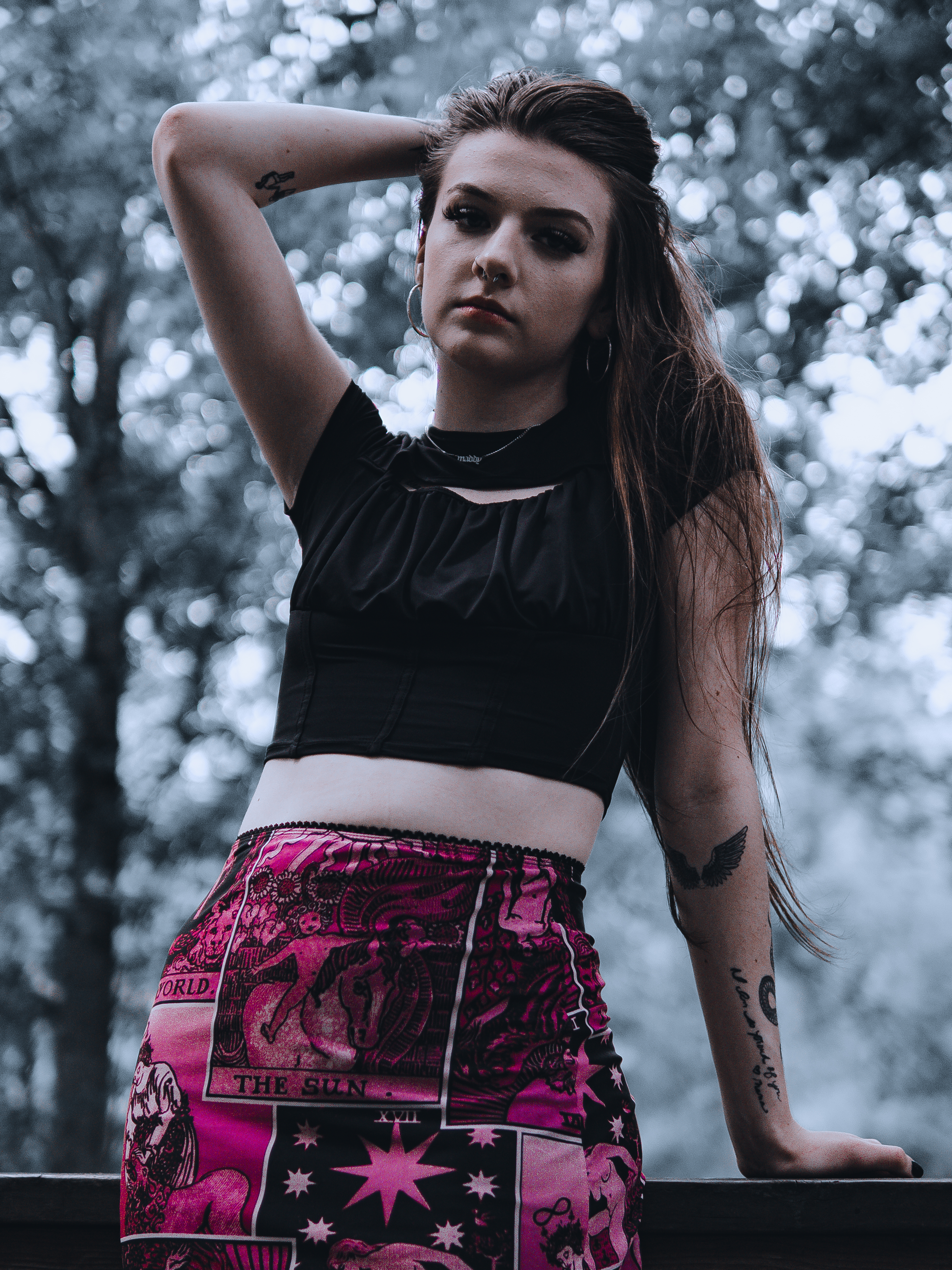 Senior portrait of a young woman posing under overcast sky