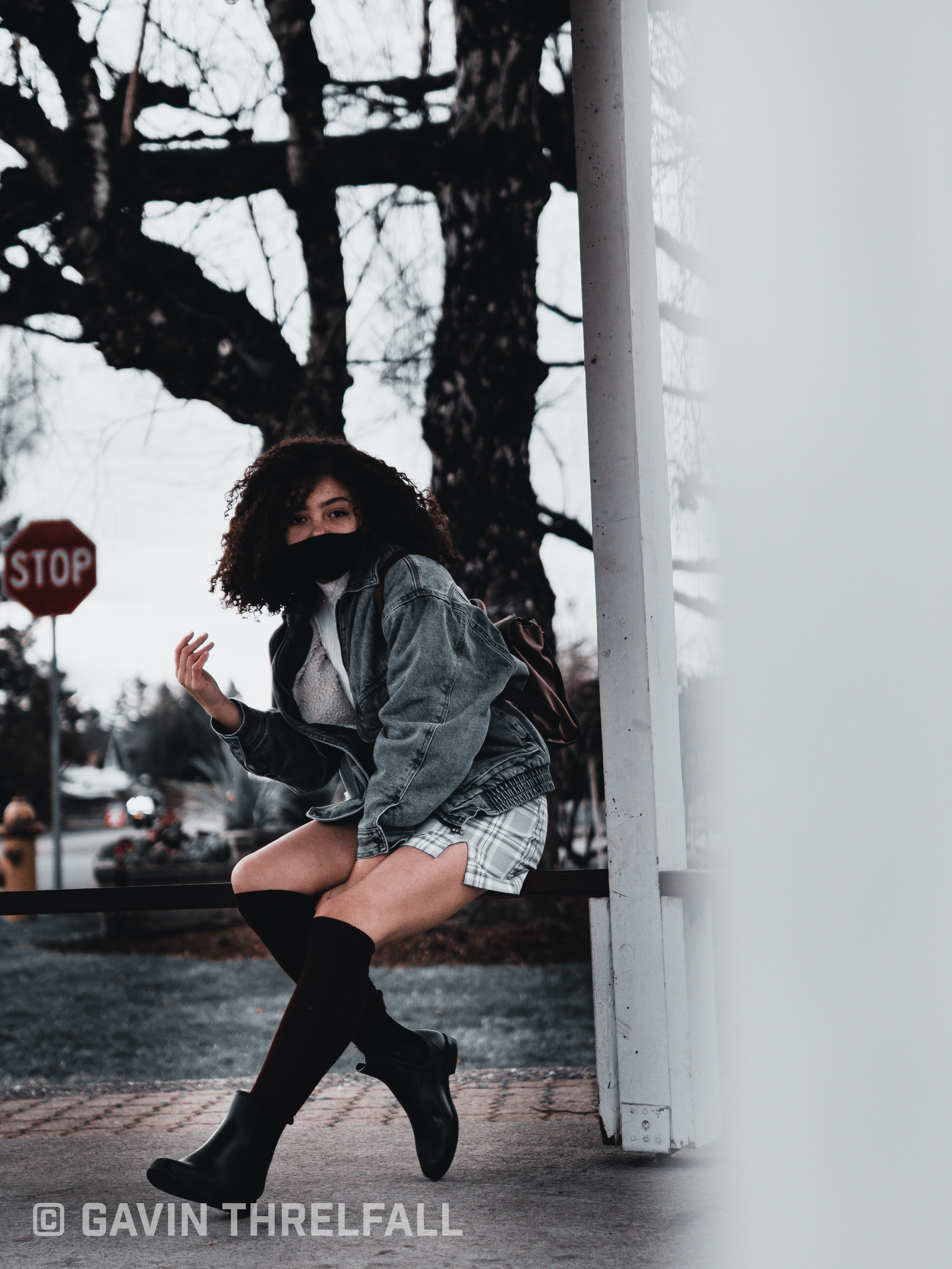 Model moving past a stop sign on a downtown corner