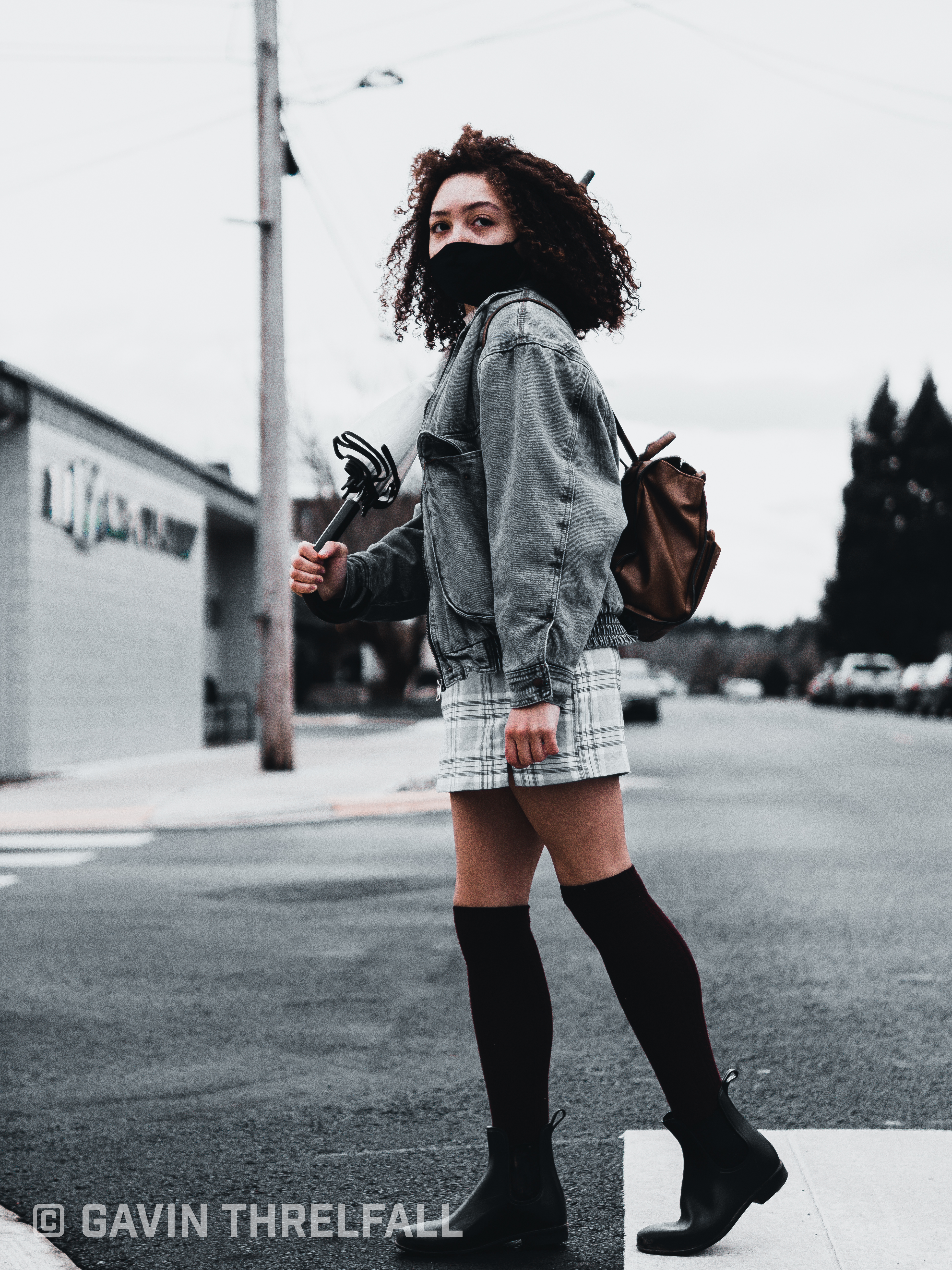 Model looking back over her shoulder while crossing the street